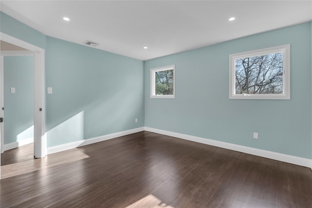 unfurnished room with wood-type flooring