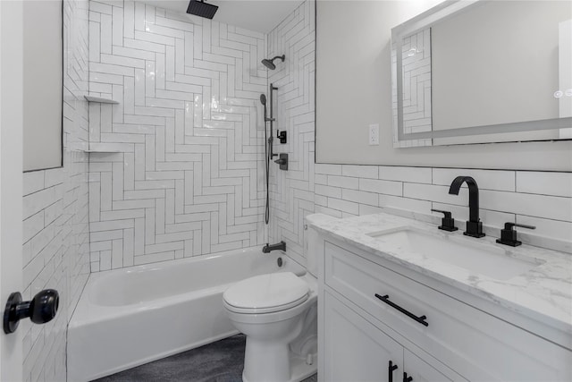 full bathroom featuring toilet, tiled shower / bath combo, and vanity