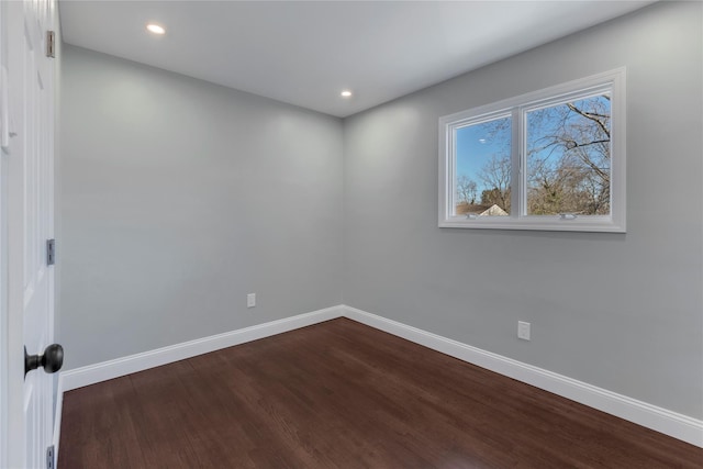 spare room with dark hardwood / wood-style floors