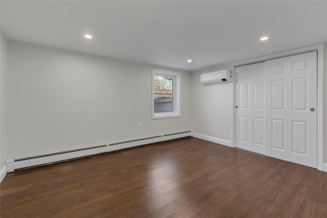 unfurnished bedroom featuring a baseboard radiator, dark hardwood / wood-style floors, a closet, and a wall unit AC