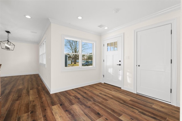 entryway with an inviting chandelier, ornamental molding, and dark hardwood / wood-style flooring