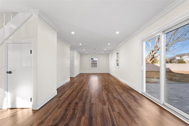 unfurnished living room featuring dark wood-type flooring and ornamental molding