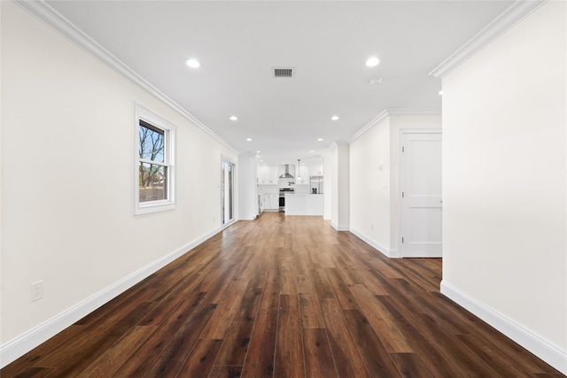 unfurnished living room featuring dark wood-type flooring and ornamental molding