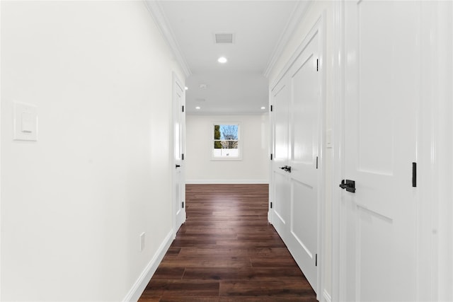 corridor featuring crown molding and dark hardwood / wood-style flooring