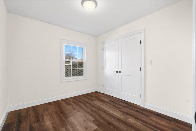 interior space featuring dark hardwood / wood-style flooring and a closet