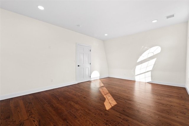 empty room with dark hardwood / wood-style flooring