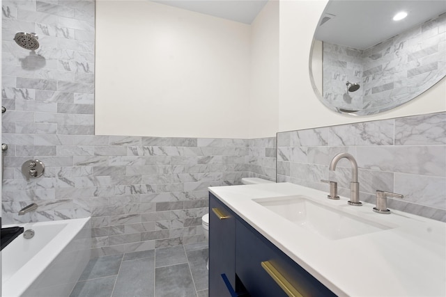 full bathroom featuring bathtub / shower combination, toilet, tile walls, vanity, and tile patterned flooring