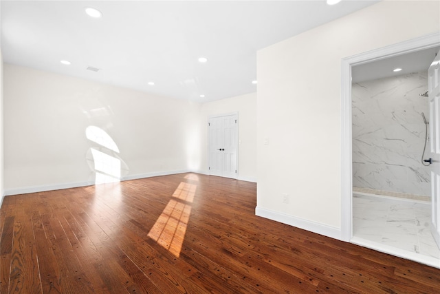 empty room with hardwood / wood-style floors