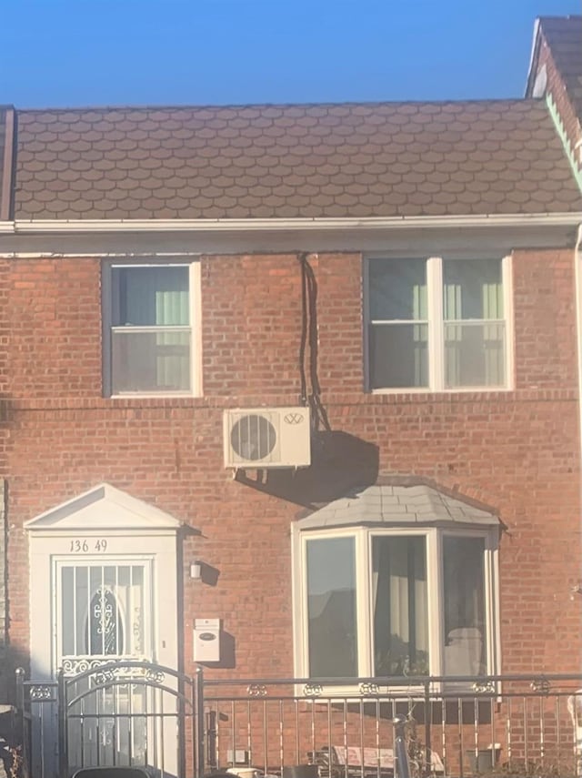 view of front of home featuring ac unit and a sunroom