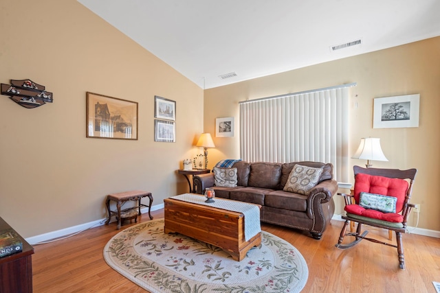 living room with lofted ceiling and light wood-type flooring