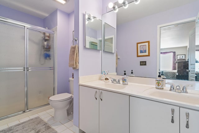 bathroom with tile patterned flooring, toilet, vanity, and a shower with shower door