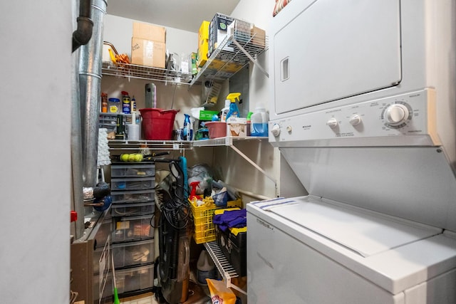 laundry room featuring stacked washer / drying machine