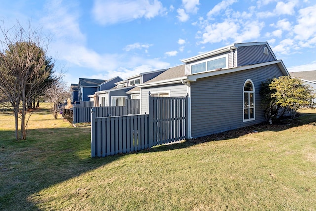 rear view of house featuring a lawn