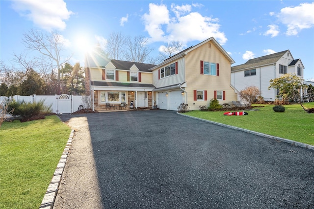 view of front property featuring a front lawn and a garage