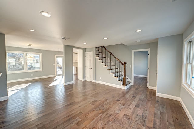 unfurnished living room with dark wood-type flooring