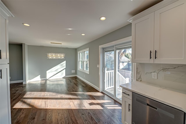 interior space featuring decorative light fixtures, white cabinetry, dishwasher, decorative backsplash, and light stone countertops