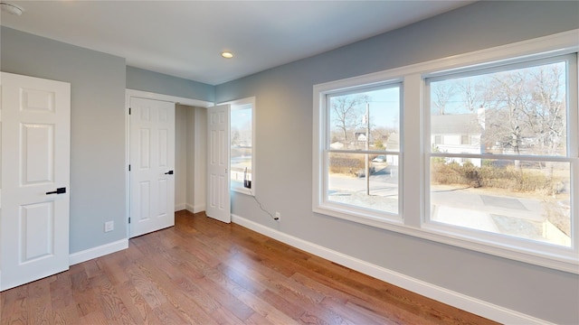 unfurnished bedroom with hardwood / wood-style flooring