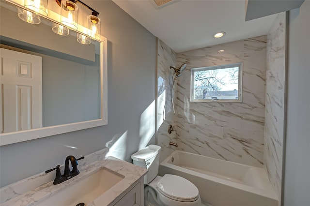 full bathroom with vanity, tiled shower / bath combo, and toilet