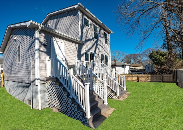 rear view of house with a lawn