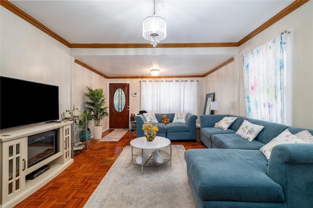 living room with a wealth of natural light, crown molding, parquet floors, and an inviting chandelier