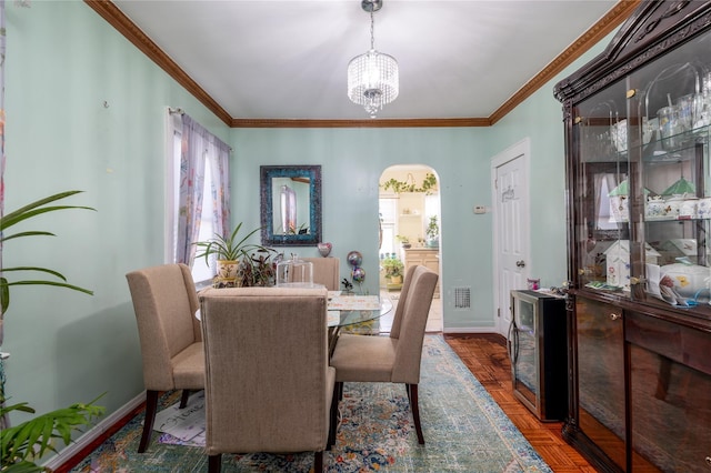 dining space featuring crown molding, a chandelier, beverage cooler, and dark parquet flooring