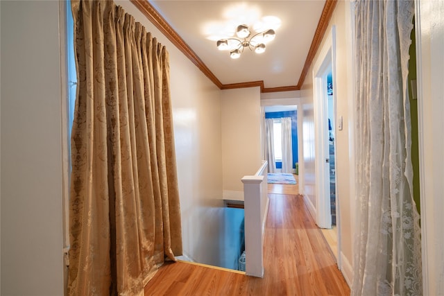 hallway featuring crown molding and light wood-type flooring