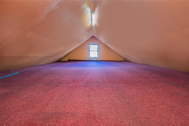 bonus room featuring carpet floors and vaulted ceiling