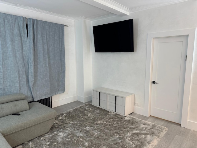 living room with hardwood / wood-style floors and crown molding