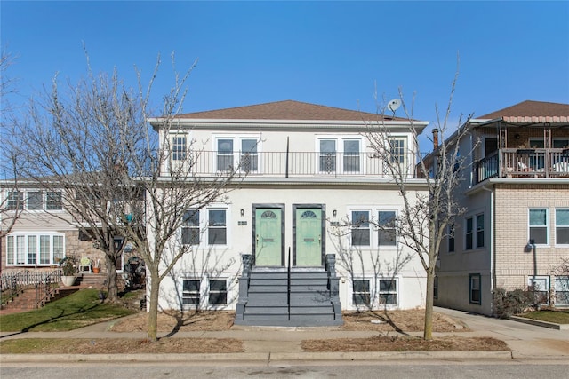 view of front of house featuring entry steps and stucco siding