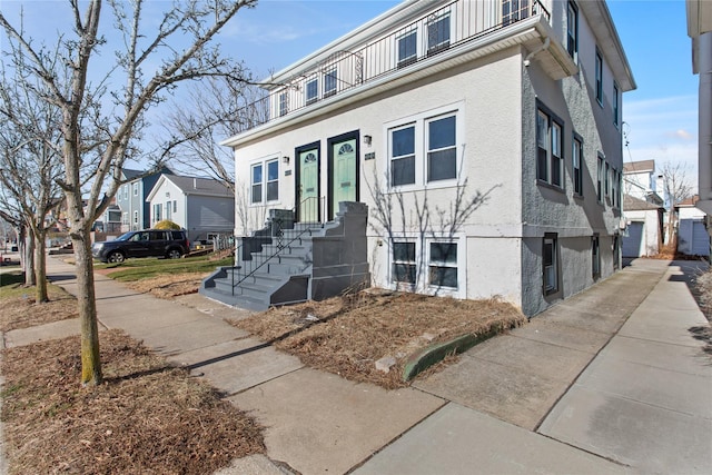 view of front of house featuring a residential view and stucco siding