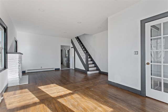 unfurnished living room with baseboards, a baseboard radiator, stairway, dark wood-style flooring, and a fireplace