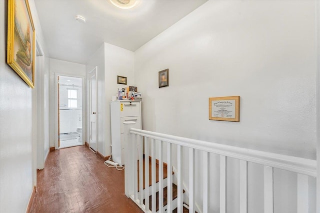 hallway with hardwood / wood-style flooring