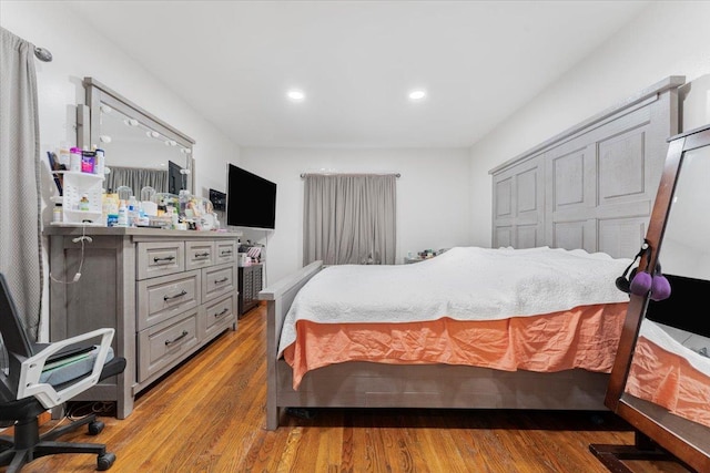 bedroom with a closet and light hardwood / wood-style floors