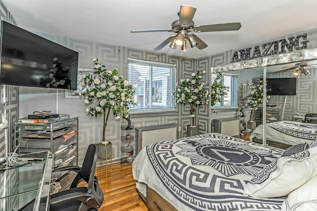 bedroom featuring ceiling fan and hardwood / wood-style floors