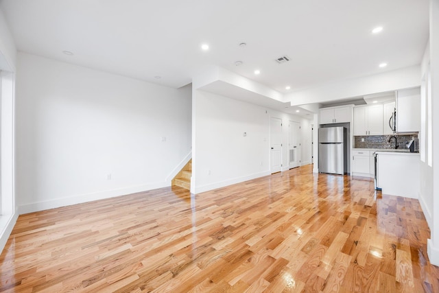 unfurnished living room featuring light hardwood / wood-style flooring