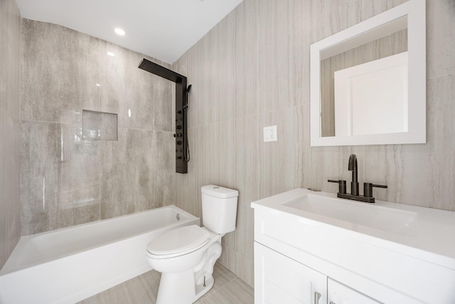 full bathroom with vanity, tiled shower / bath combo, and toilet