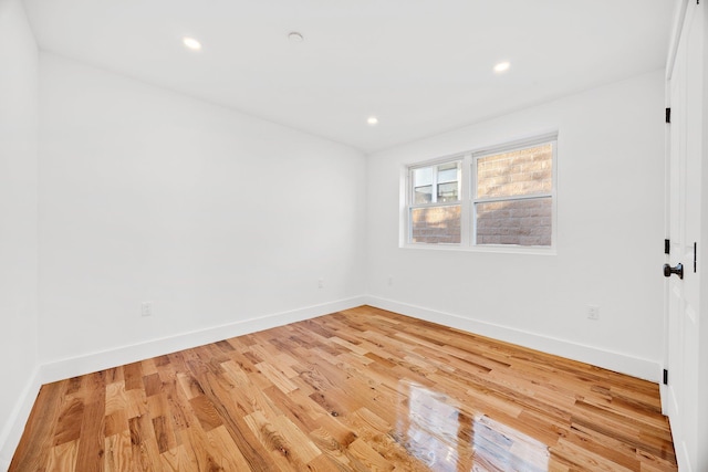 spare room with hardwood / wood-style flooring