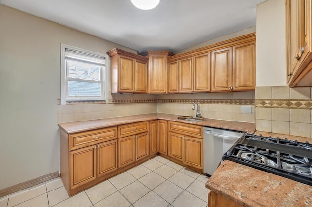 kitchen with brown cabinetry, backsplash, stainless steel dishwasher, a sink, and light tile patterned flooring