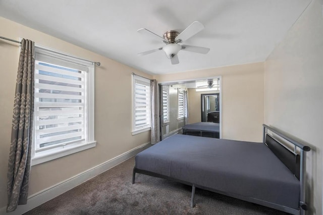 bedroom with dark colored carpet, ceiling fan, and baseboards