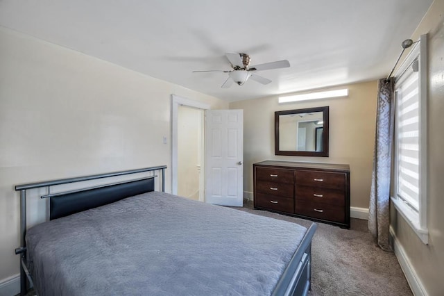 bedroom featuring ceiling fan, dark colored carpet, and baseboards