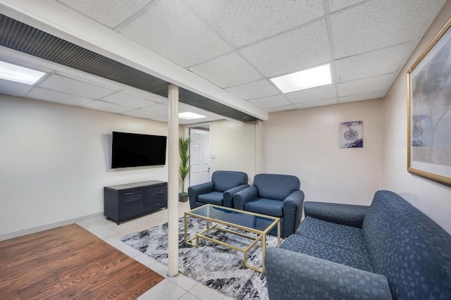 living room featuring a drop ceiling and wood finished floors