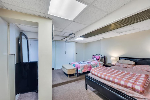 carpeted bedroom featuring a paneled ceiling