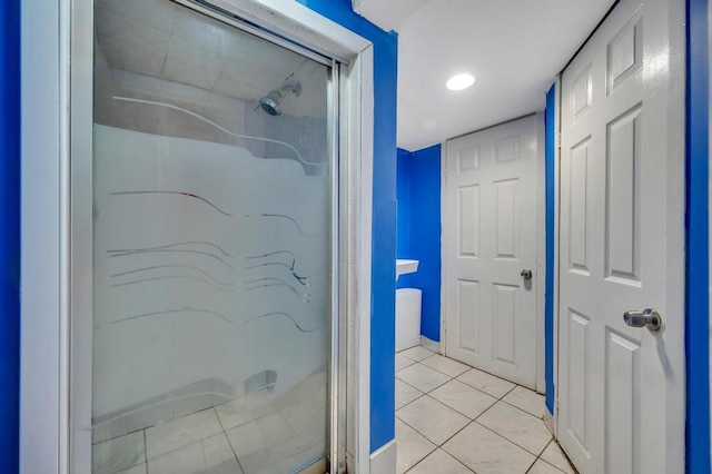 full bathroom featuring a stall shower and tile patterned flooring