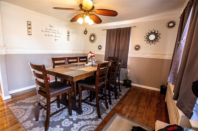 dining room featuring dark hardwood / wood-style floors, ceiling fan, and ornamental molding