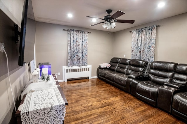 living room featuring ceiling fan, dark wood-type flooring, and radiator