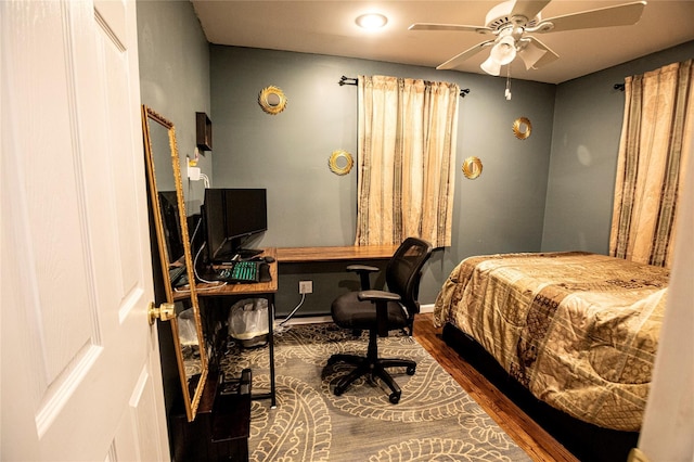 bedroom with hardwood / wood-style floors and ceiling fan