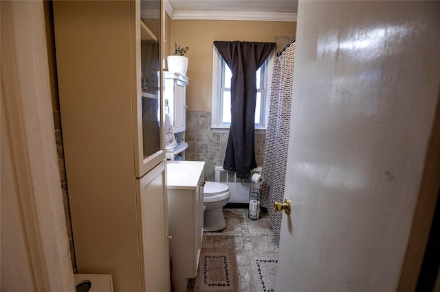 bathroom featuring vanity, toilet, curtained shower, and ornamental molding