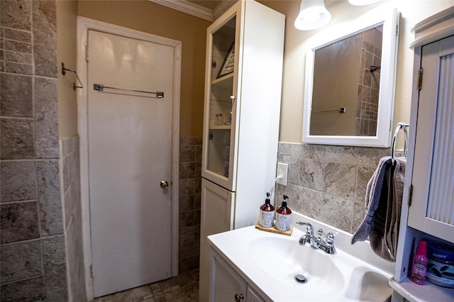 bathroom with decorative backsplash, vanity, and ornamental molding