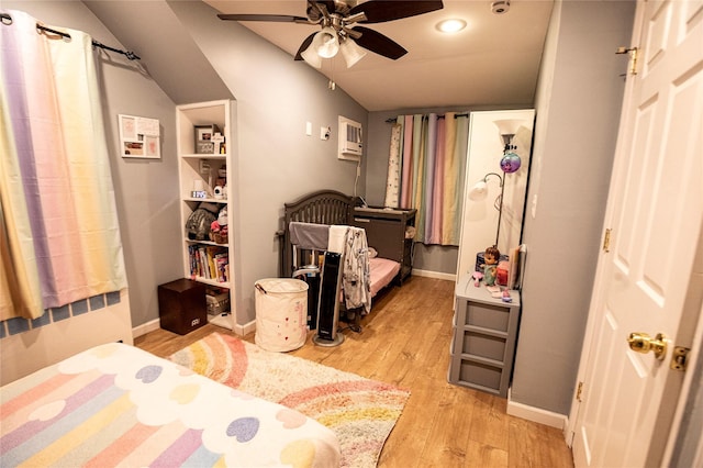 bedroom with ceiling fan, light hardwood / wood-style floors, and vaulted ceiling