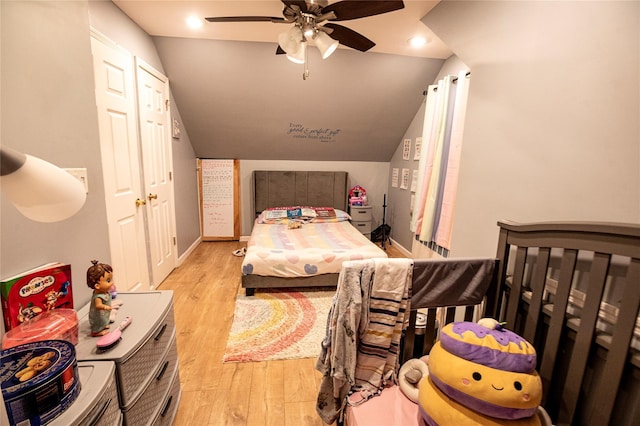 bedroom featuring ceiling fan, light hardwood / wood-style floors, and lofted ceiling